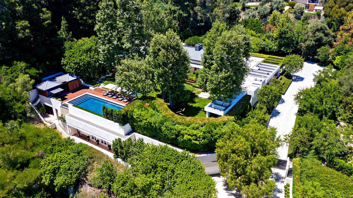 The three-acre compound includes a 9,000-square-foot main house, two guesthouses, a pool house, detached gym and underground garage.