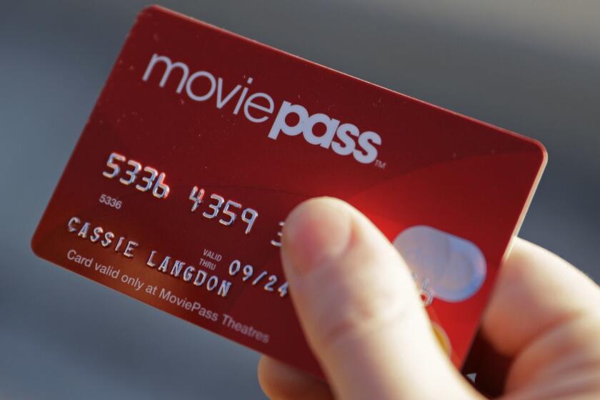In this Tuesday, Jan. 30, 2018, photo, Cassie Langdon holds her MoviePass card outside AMC Indianapolis 17 theatre in Indianapolis. With MoviePass, Langdon said she's taking more chances on smaller releases instead of sticking with blockbusters and their sequels. (AP Photo/Darron Cummings)