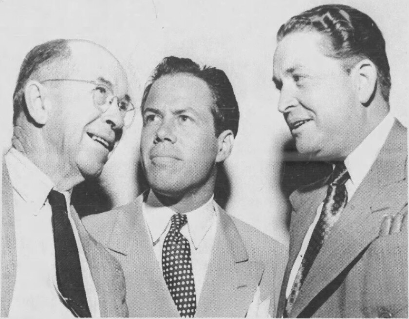 Three men in a black and white photo