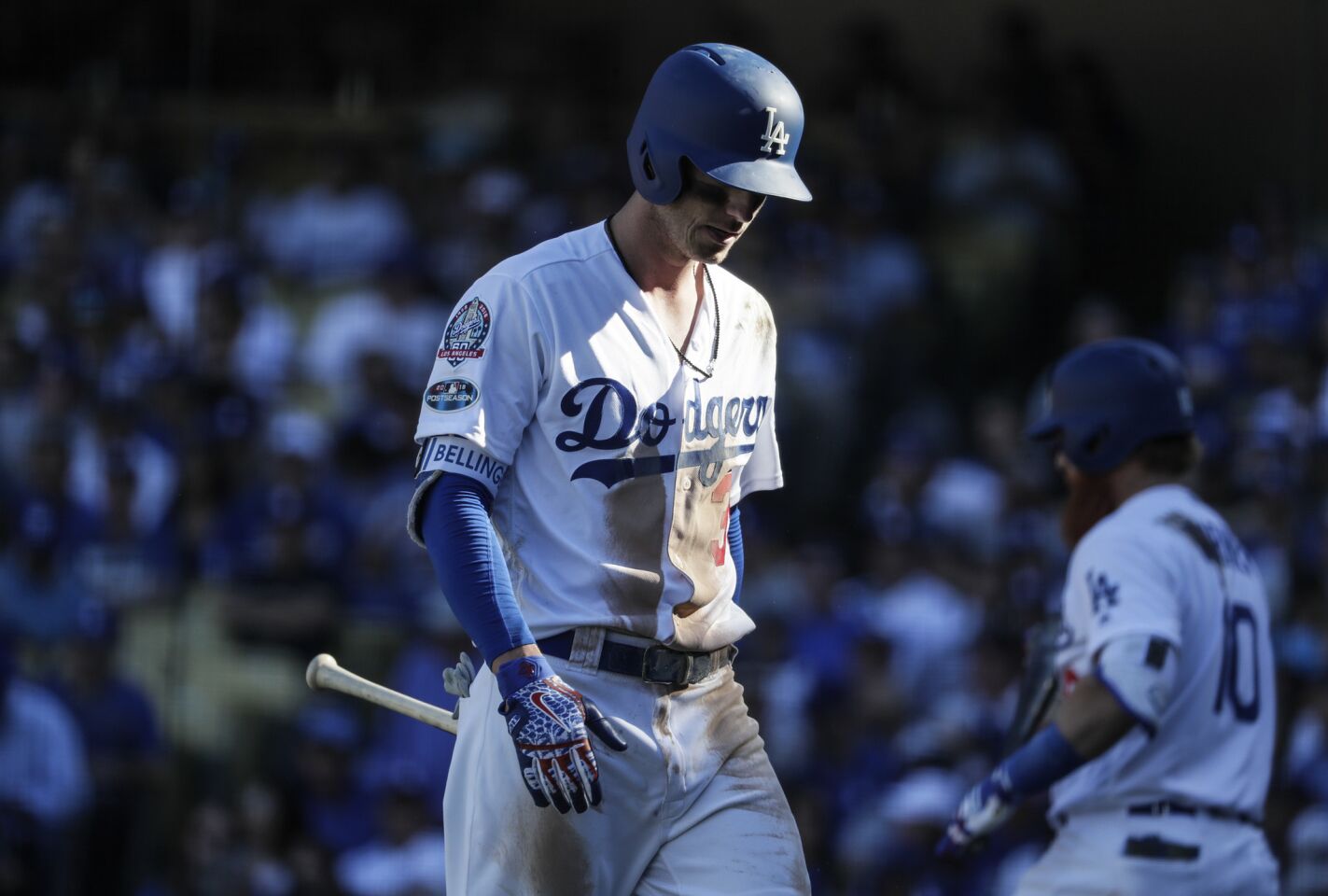 Cody Bellinger walks slowly back to the dugout after striking out in the third inning.