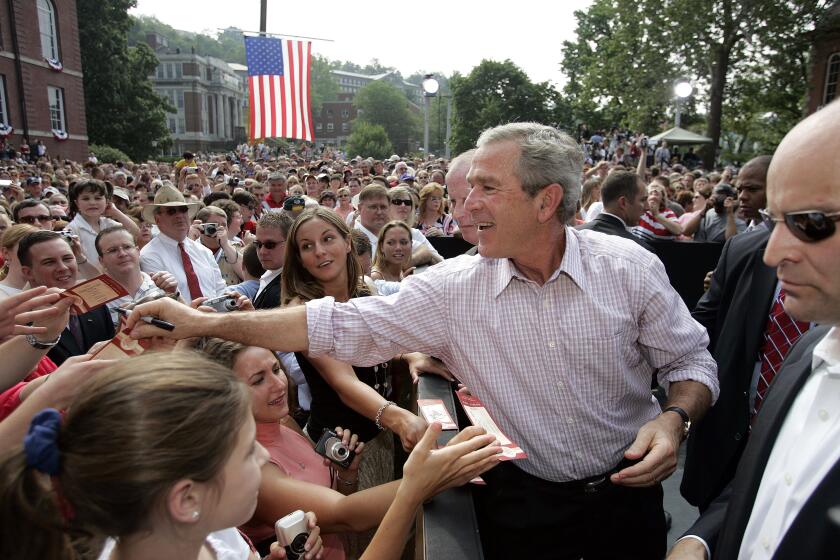 FILE - President George W. Bush greets the crowd after delivering remarks at Independence Day celebrations at West Virginia University in Morgantown, W.V., July 4, 2005. (AP Photo/Gerald Herbert, File)