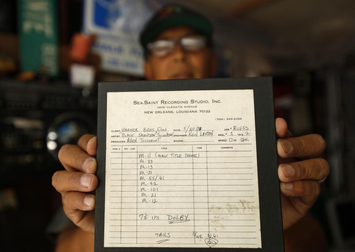 Mike Nishita holds up a tape of the soundtrack from the 1974 movie "Black Samson," produced by New Orleans legend Allen Toussaint. Never released, it's part of an invaluable collection, lost after Hurricane Katrina, that Nishita purchased at a Torrance swap meet.