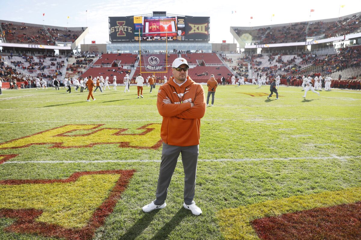 Texas coach Tom Herman stands on the field before a game