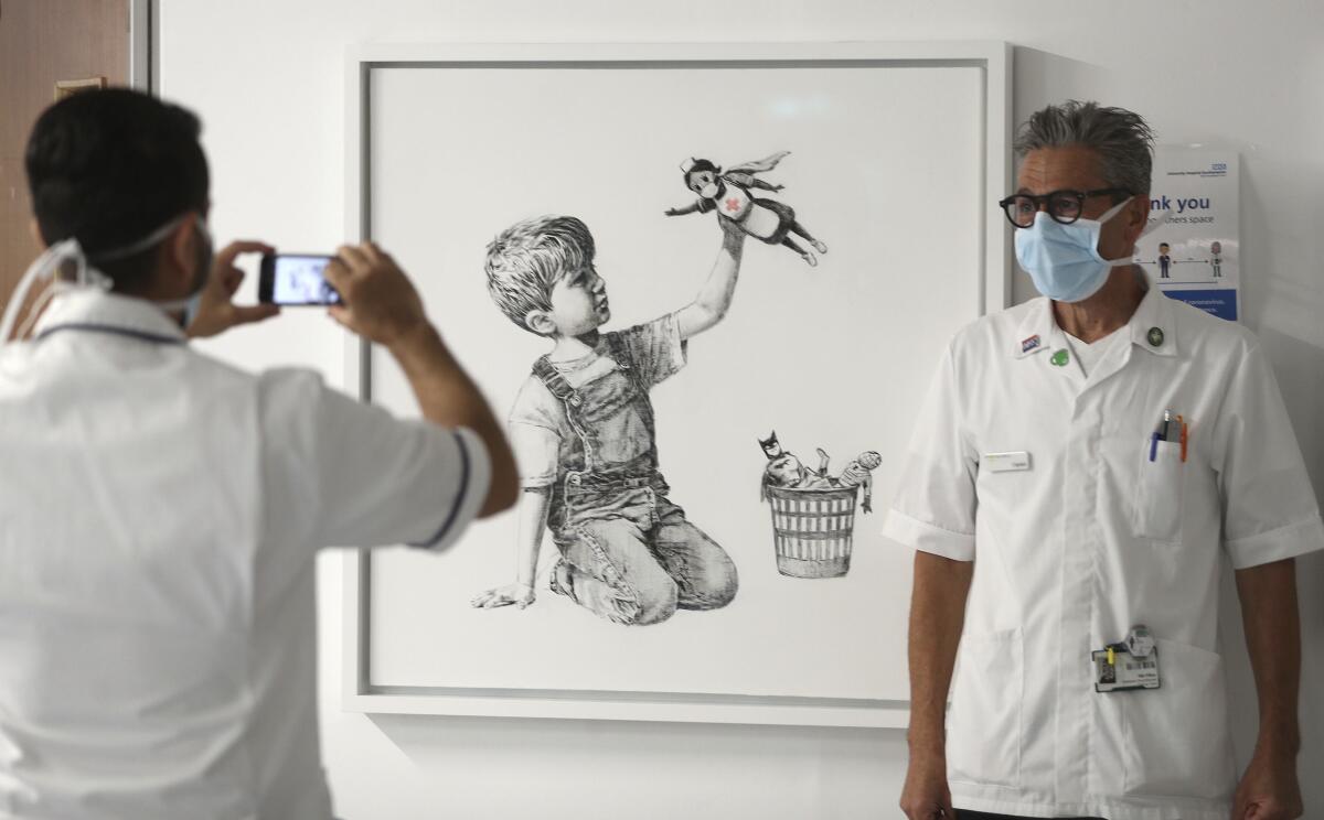 Banksy's new painting, in honor of Britain's healthcare workers, has gone on display in a hospital in Southampton, England.