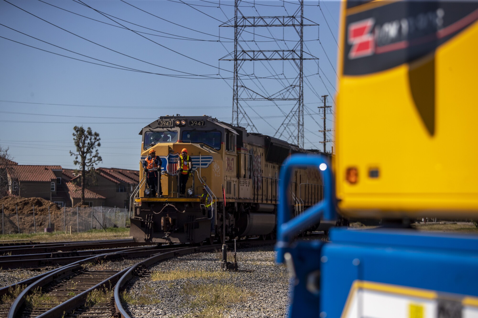 A yellow locomotive rounds a curve.