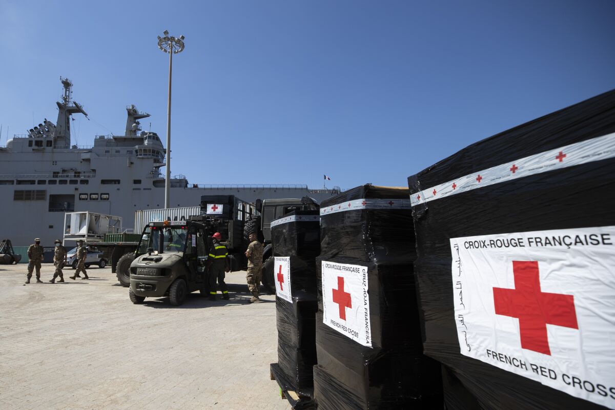 French troops help unload boxes of French Red Cross humanitarian aid