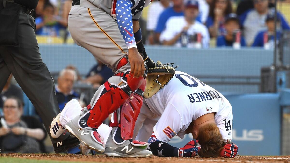 Dodgers' Justin Turner is down after being hit in the head by a pitch from Pittsburgh Pirates pitcher Tyler Glasnow in the fifth inning at Dodger Stadium on Wednesday.