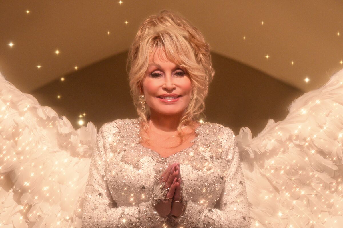Dolly Parton in an angelic white costume