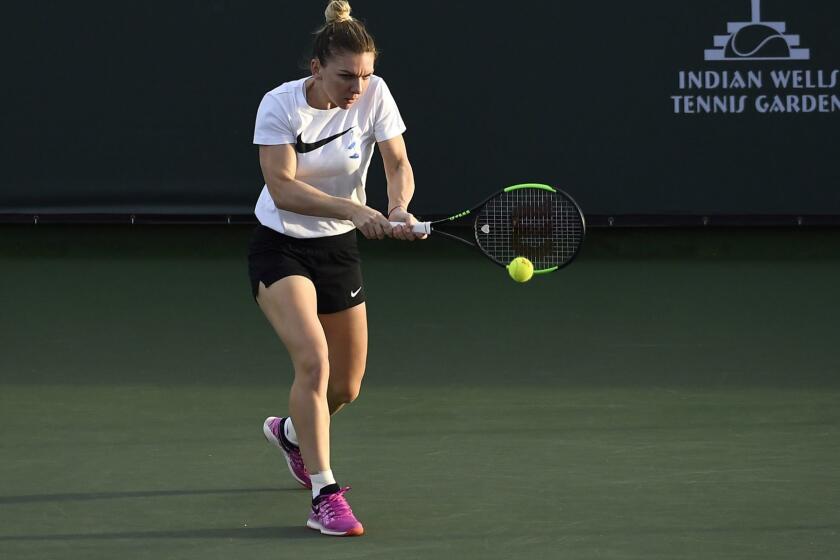 INDIAN WELLS, CA - MARCH 06: Simona Halep hits a backhand during warm up on practice courts during day three of the BNP Paribas Open as storm clouds pass over the mountains on March 6, 2019 in Indian Wells, California. (Photo by Kevork Djansezian/Getty Images) ** OUTS - ELSENT, FPG, CM - OUTS * NM, PH, VA if sourced by CT, LA or MoD **