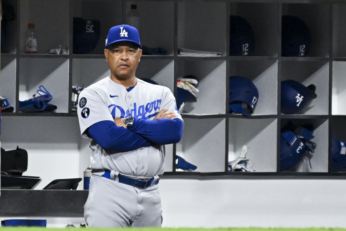 Dodgers manager Dave Roberts watches Game 3 of the NLDS in San Diego from the dugout.