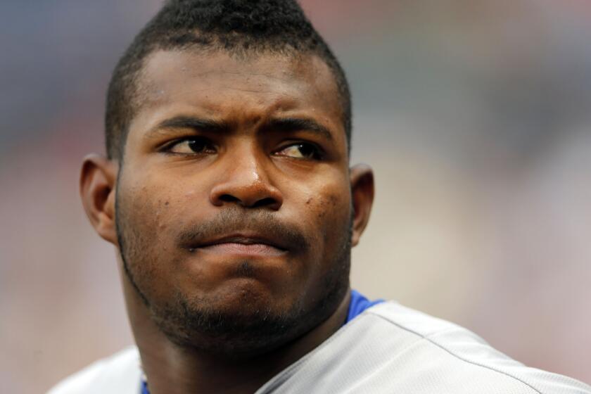 Yasiel Puig looks on from the dugout on July 20.