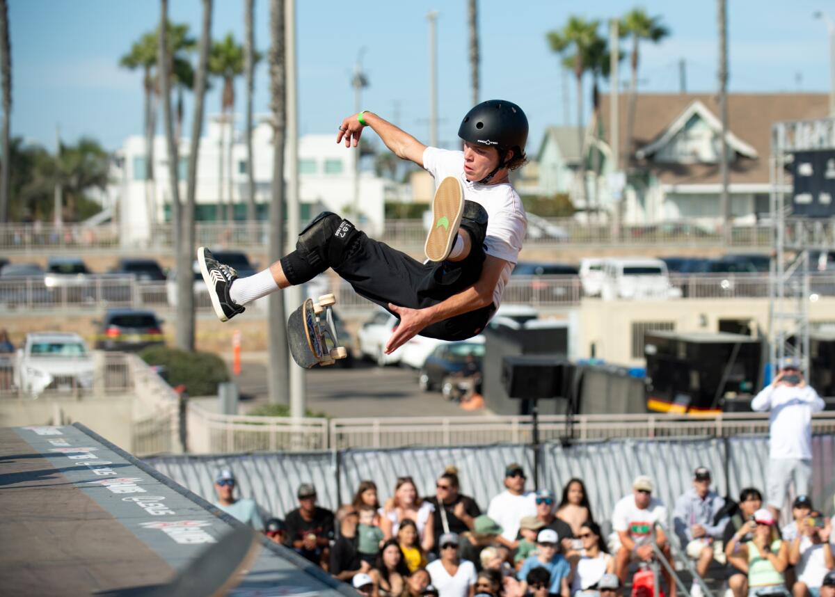 Skaters demonstrate skills on a vert ramp built on the sand south of Huntington Beach Pier on Aug. 3.