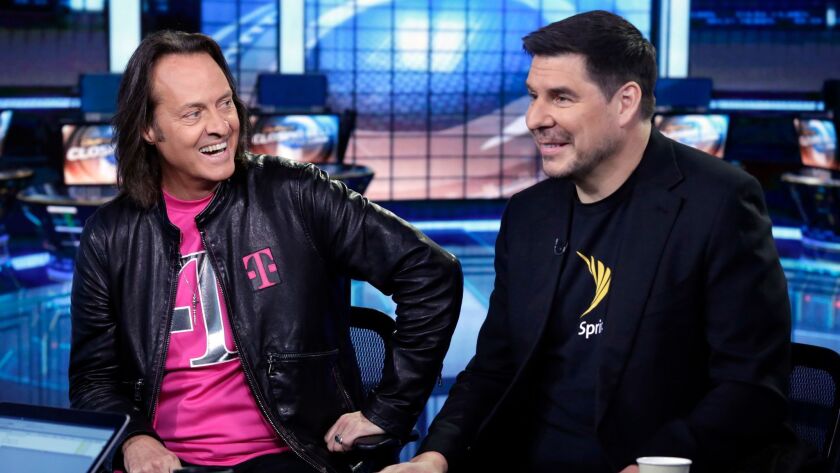 T-Mobile CEO John Legere, left, and Sprint CEO Marcelo Claure look to gain approval for their multibillion-dollar merger.