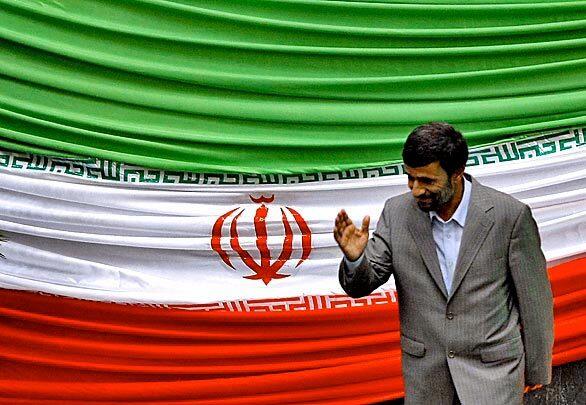 Iranian President Mahmoud Ahmadinejad waves as he leaves the podium after having taken the oath of office.