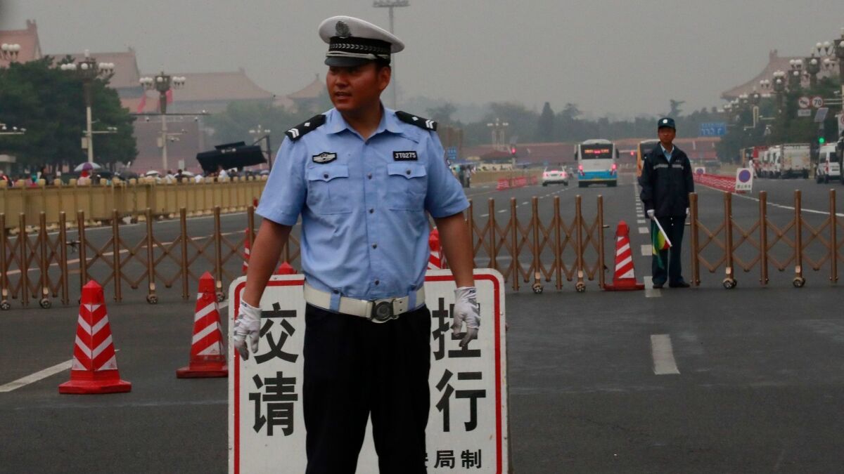 Police guard the entrance to a road along the east side of Tiananmen Square on June 4, the 30th anniversary of the protests in Beijing.