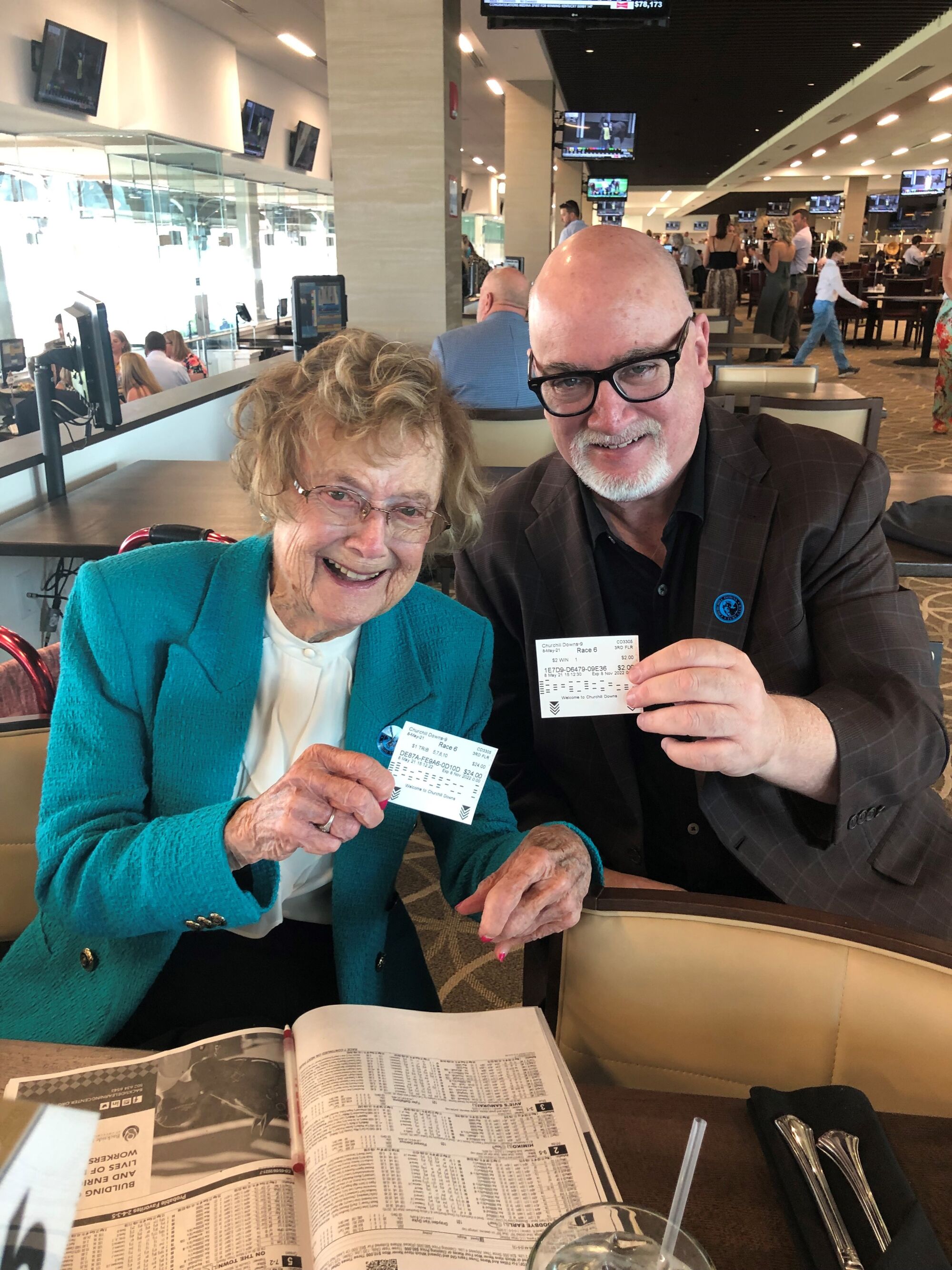 Bill Plaschke and his mother, Mary, hold up their betting tickets at Churchill Downs.