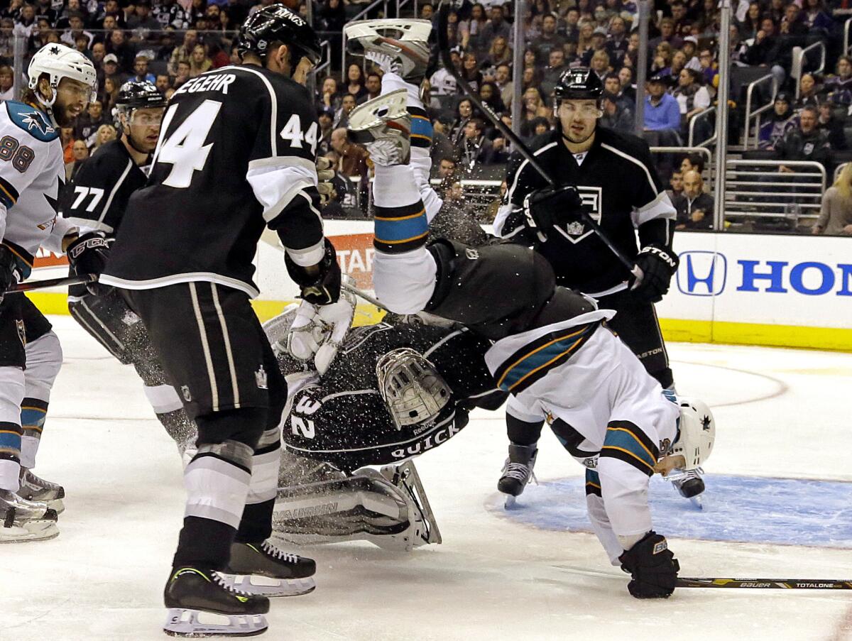 San Jose Sharks left wing T.J. Galiardi goes flying as he tangles with Kings goalie Jonathan Quick.