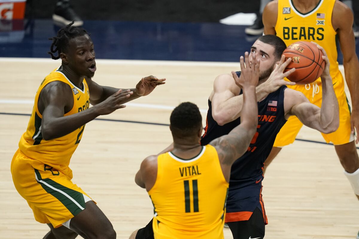 Illinois' Giorgi Bezhanishvili (15) looks to shoot as Baylor's Mark Vital (11) and Jonathan Tchamwa Tchatchoua (23) defend during the first half of an NCAA college basketball game Wednesday, Dec. 2, 2020, in Indianapolis. (AP Photo/Darron Cummings)