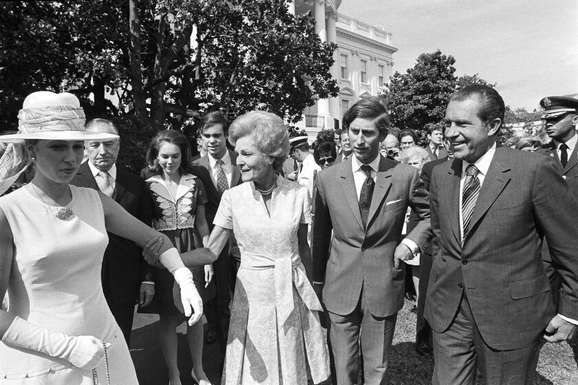 FILE - First lady Pat Nixon leads Princess Anne Thursday, July 16, 1970, from welcoming ceremonies at the White House. President Richard Nixon and Prince Charles walk with them. In the background are Julie and David Eisenhower. (AP Photo, File)
