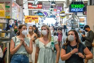 Visitors to the Grand Central Market are mostly masked