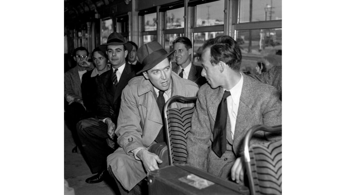 Mar. 22, 1941. Actor Jimmy Stewart talking to fellow Army inductees on Red Car train.