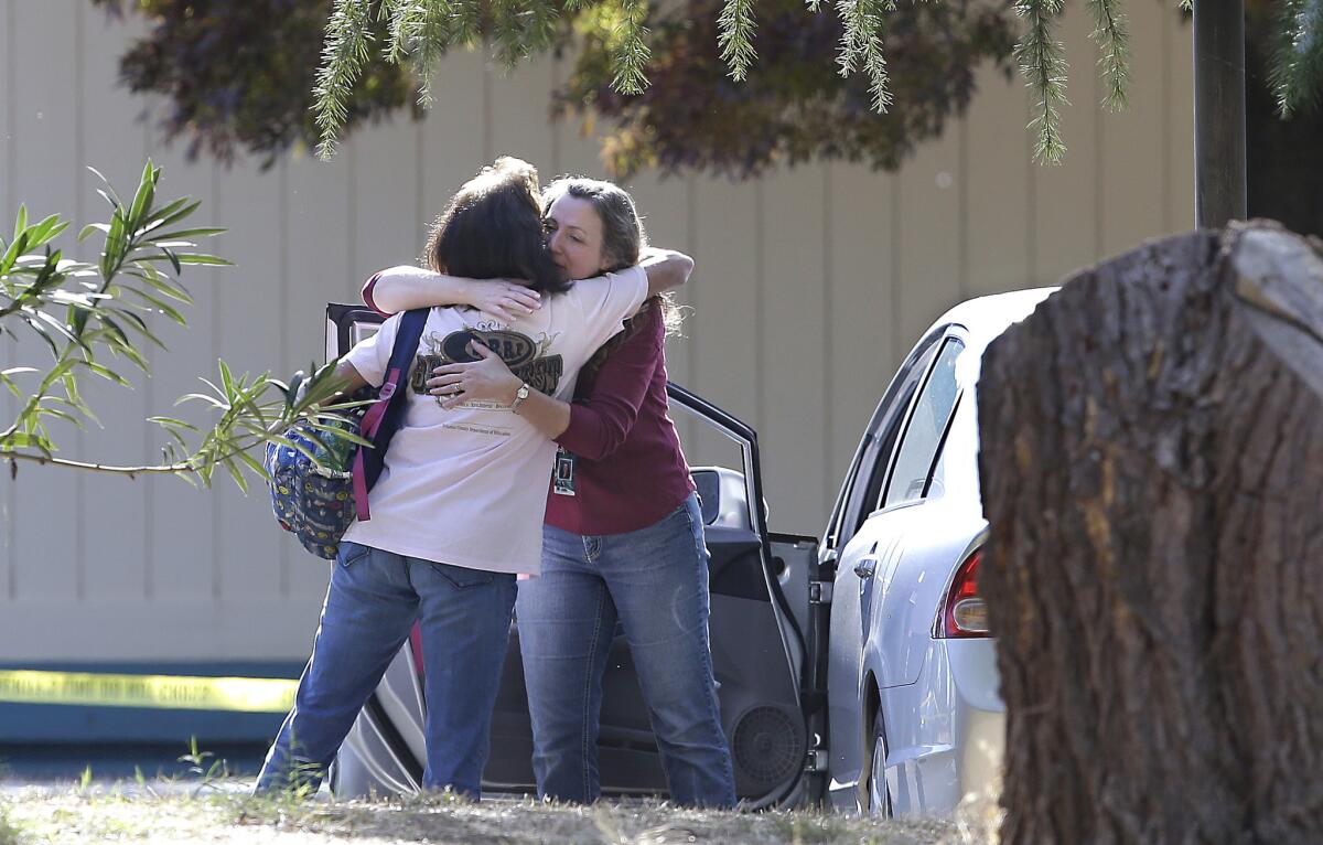Two women embrace outside Rancho Tehama Elementary School in Corning, Calif., where a gunman opened fire Tuesday.