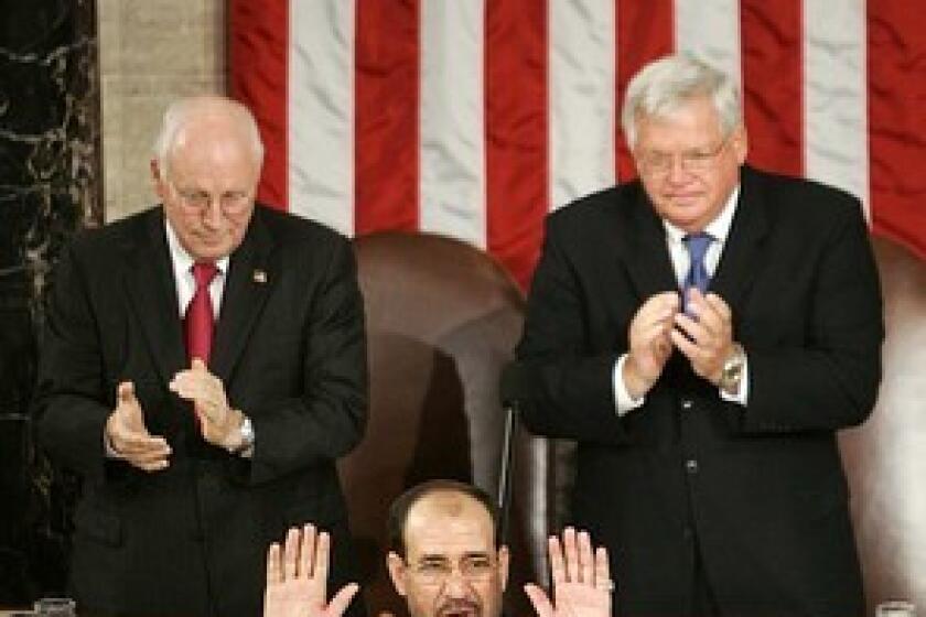 Vice President Dick Cheney, left, and then-House Speaker J. Dennis Hastert applaud during Iraqi Prime Minister Nouri Maliki's speech to a joint meeting of Congress in 2006.