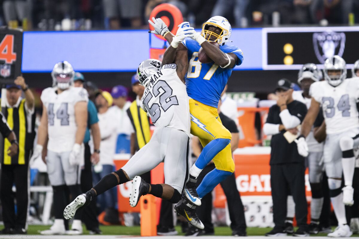 Chargers' Jared Cook (87), catches a pass over Raiders' Denzel Perryman during their game on Oct. 4.