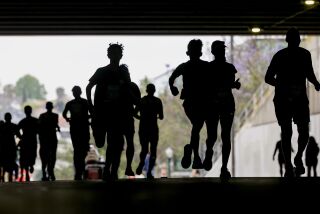 SAN DIEGO, CA - JUNE 04, 2023: Runners move through the San Diego City College tunnel as they head west on B Street in downtown San Diego during the Rock 'n' Roll San Diego Marathon on Sunday, June 4, 2023. (Hayne Palmour IV / For The San Diego Union-Tribune)