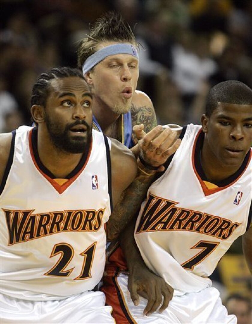 Denver Nuggets' Chris Anderson, center, is blocked out by Golden State Warriors' Ronny Turiaf (21) and Kelenna Azubuike (7) during the first half of an NBA basketball game Wednesday, Nov. 5, 2008, in Oakland, Calif. (AP Photo/Ben Margot)