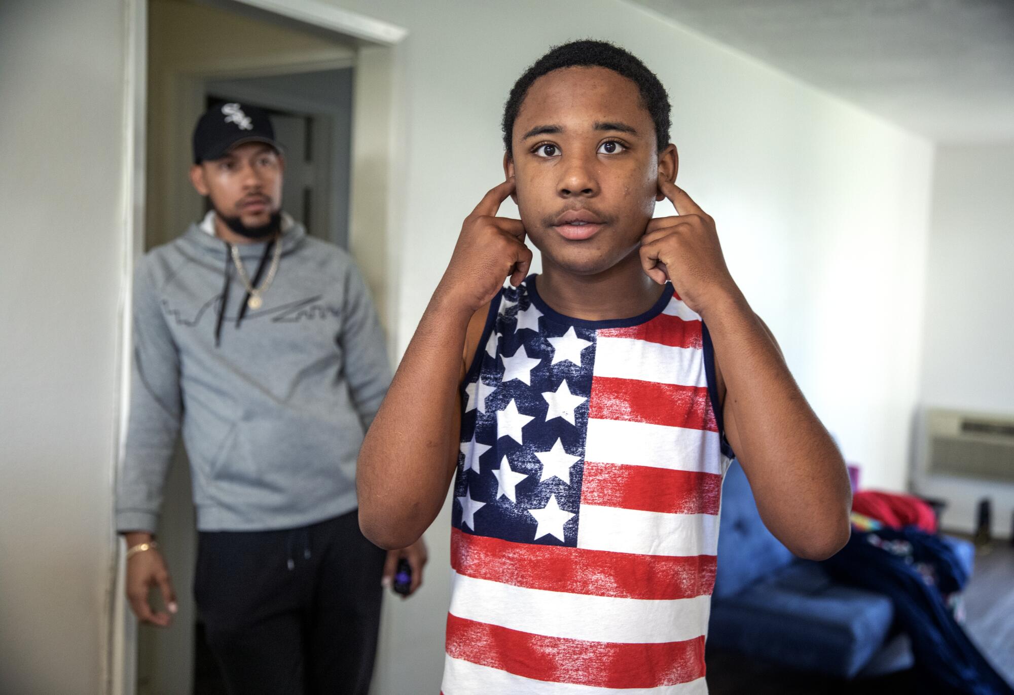 Caregiver Terrence Morris, left, keeps a watchful eye on Noah