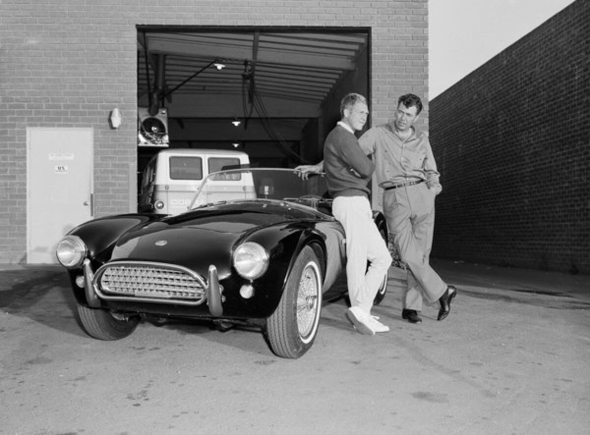 Actor Steve McQueen, left, and racer Carroll Shelby stand by McQueen's Ford Cobra roadster in 1963 in Los Angeles. Shelby's former Marina del Rey headquarters was sold.