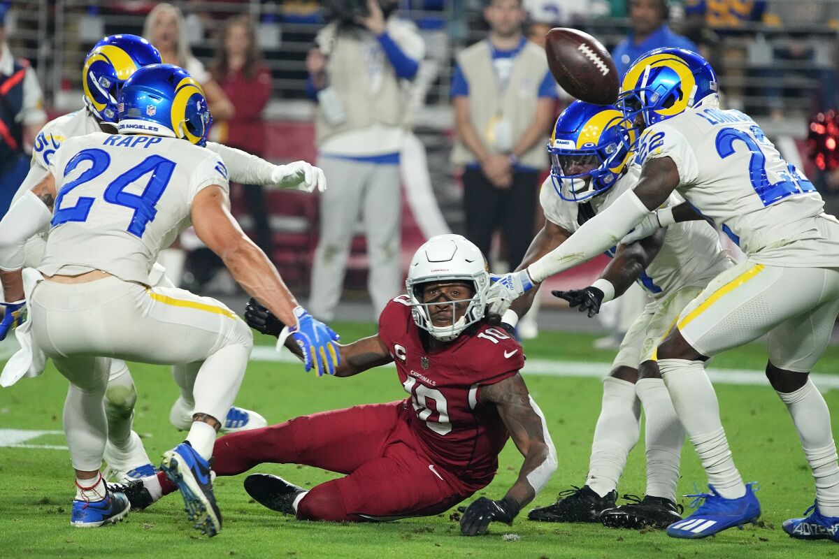 Arizona Cardinals wide receiver DeAndre Hopkins (10) is surrounded after he is unable to make a catch between Los Angeles Rams inside linebacker Ernest Jones (50), free safety Taylor Rapp (24), cornerback Darious Williams, second from right, and defensive back David Long (22) during the second half of an NFL football game Monday, Dec. 13, 2021, in Glendale, Ariz. (AP Photo/Rick Scuteri)