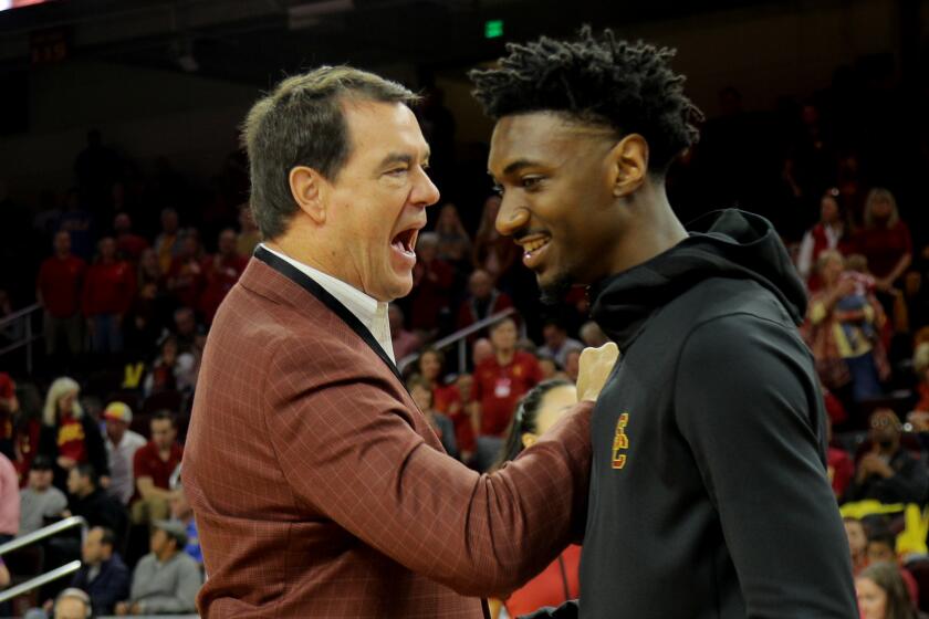 LOS ANGELES, CA - MARCH 7, 2020: USC Athletic Director Mike Bohn congratulates USC Trojans guard Jonah Mathews (2) during a senior recognition ceremony before the game against UCLA at Galen Center on March 7, 2020 in Los Angeles, California. (Gina Ferazzi/Los AngelesTimes)