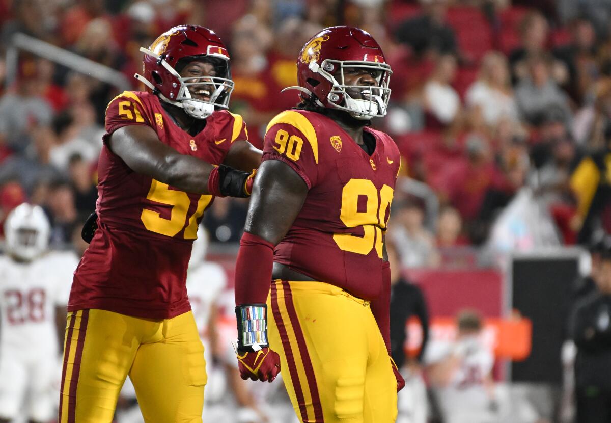 USC defensive lineman Bear Alexander, right, celebrates with teammate Solomon Byrd after tipping a pass.