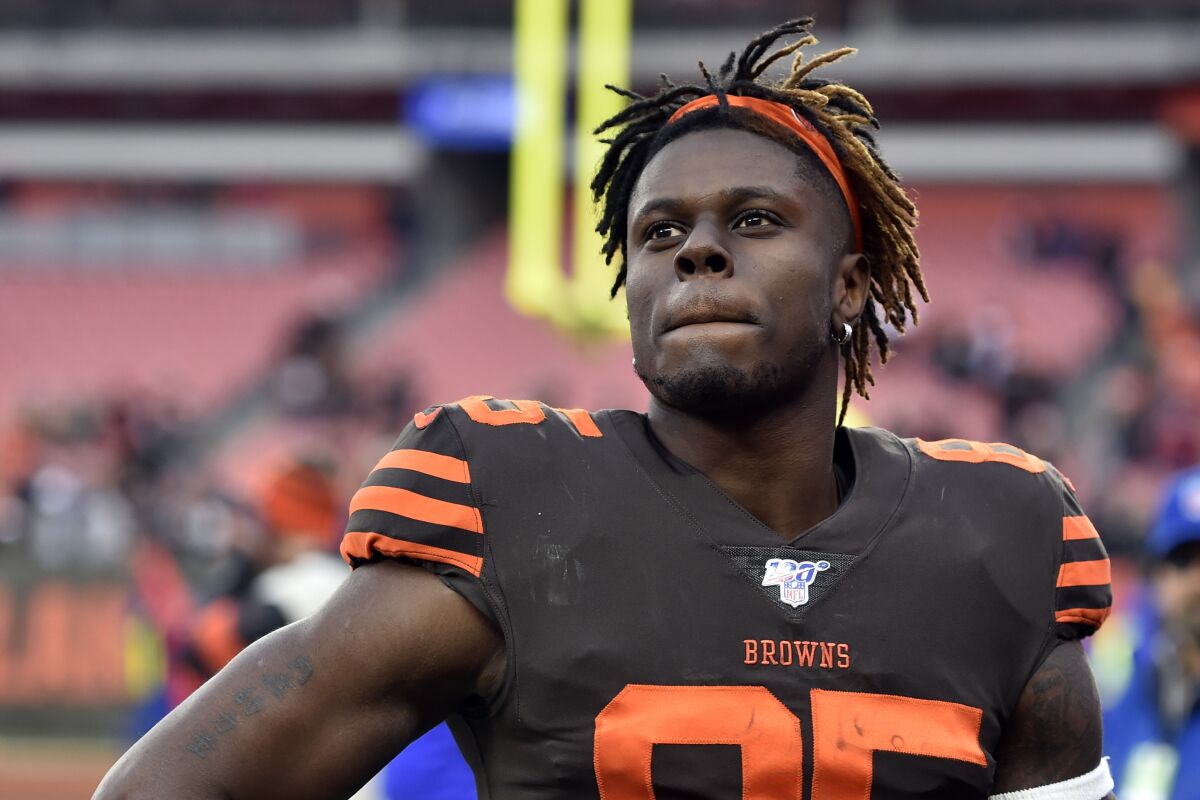 FILE - In this Dec. 8, 2019, file photo, Cleveland Browns tight end David Njoku walks off the field after an NFL football game against the Cincinnati Bengals in Cleveland. After demanding a trade last month, Njoku seemed to indicate on Saturday, Aug. 1, 2020, that he's changed his mind. The 2017 first-round draft pick tweeted, "I’m all in Cleveland. Time to work.‘’ (AP Photo/David Richard, File)