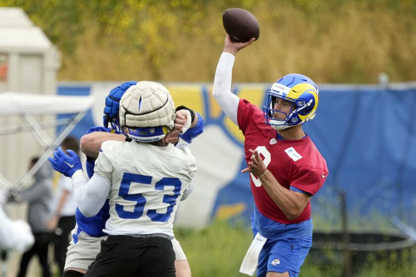  Rams quarterback Matthew Stafford throws during the team's organized team activities.