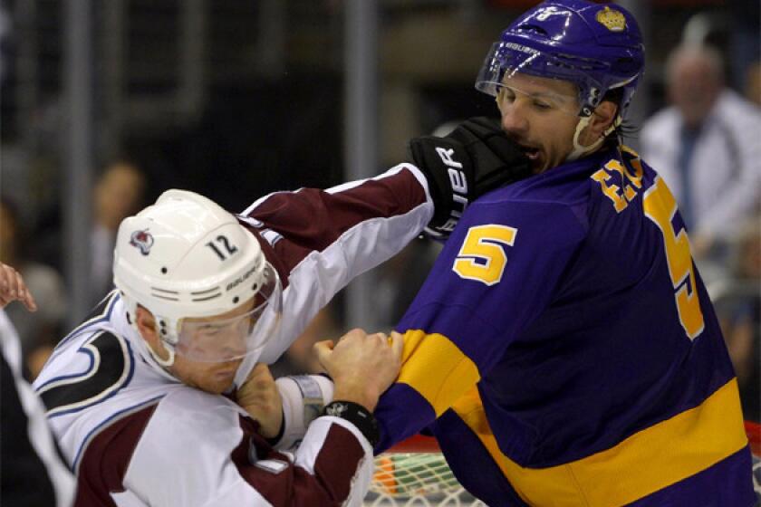 Kings defenseman Keaton Ellerby, right, fights Colorado Avalanche right wing Chuck Kobasew.