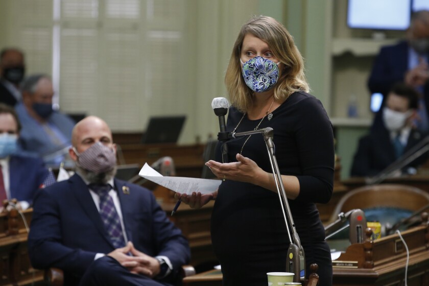 California Assembly Member Buffy Wicks of Oakland stands and speaks.