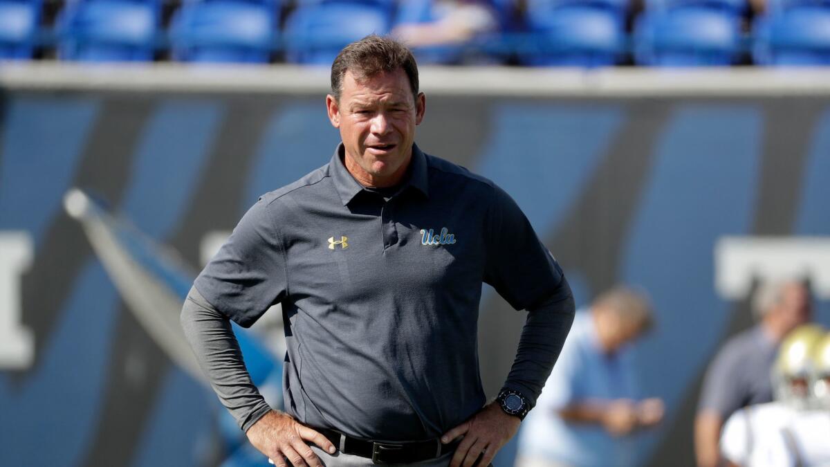 UCLA coach Jim Mora watches as players warm up before the start of a Sept. 16 game against Memphis in Memphis, Tenn.