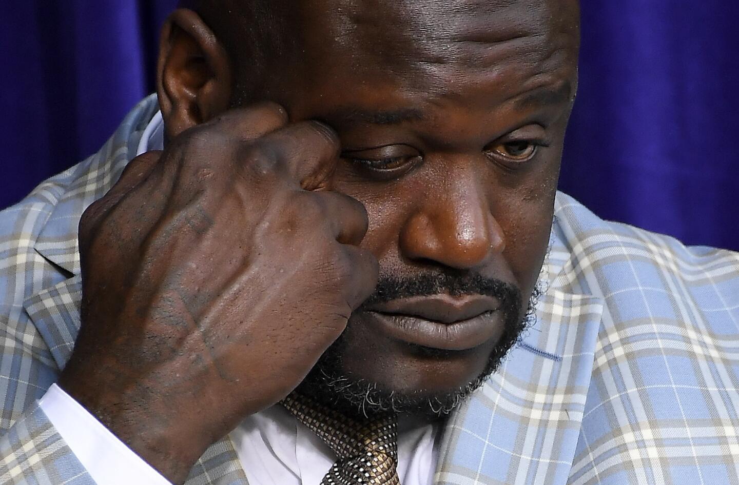 Shaquille O'Neal wipes tears from his eyes at the unveiling of a statue of him in front of Staples Center, Friday, March 24, 2017, in Los Angeles. (AP Photo/Mark J. Terrill)