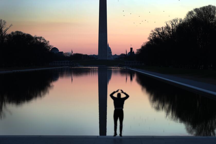 WASHINGTON, DC - JANUARY 07: A person exercises as the U.S. Capitol is seen behind the Washington Monument across from the Reflecting Pool the day after a pro-Trump mob broke into the building on January 07, 2021 in Washington, DC. Congress finished tallying the Electoral College votes and Joe Biden was certified as the winner of the 2020 presidential election. Photo by Joe Raedle/Getty Images)