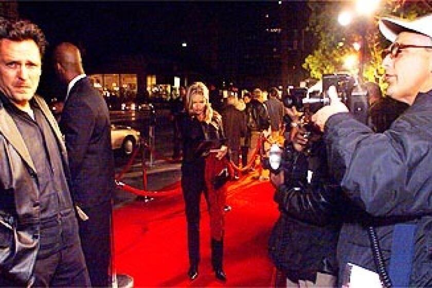 Celebrity photographer Jim Smeal on the red carpet photographing celebrity Michael Madsen at a screening in Beverly Hills.