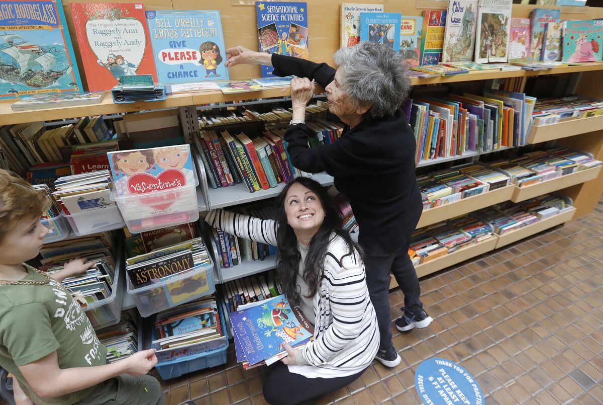 Sheila Plotkin works in the Friends of the Library store at Huntington Beach's Central Library, while Amber Cambria helps.