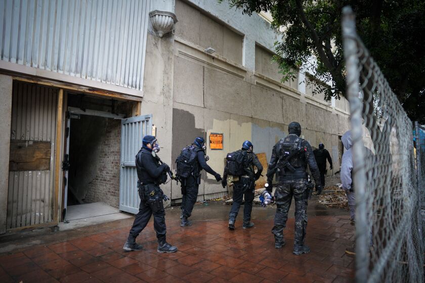 San Diego, CA - November 02: Armed private security personnel exit from the California Theatre property in downtown on Wednesday, Nov. 2, 2022 in San Diego, CA. The security personnel did an inspection of the building to insure that no one was possibly still inside. (Nelvin C. Cepeda / The San Diego Union-Tribune)