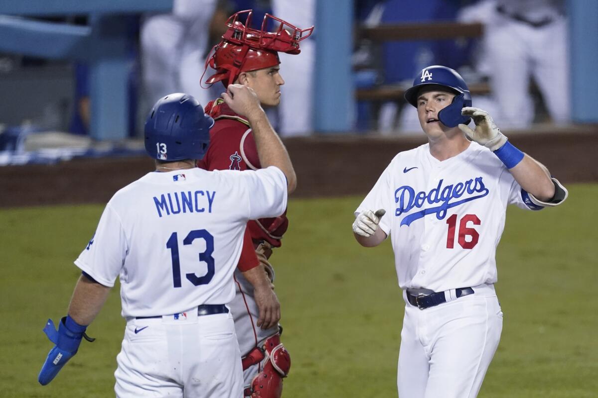 Will Smith is greeted by Max Muncy after hitting a go-ahead, two-run homer for the Dodgers in the fifth inning Friday night.