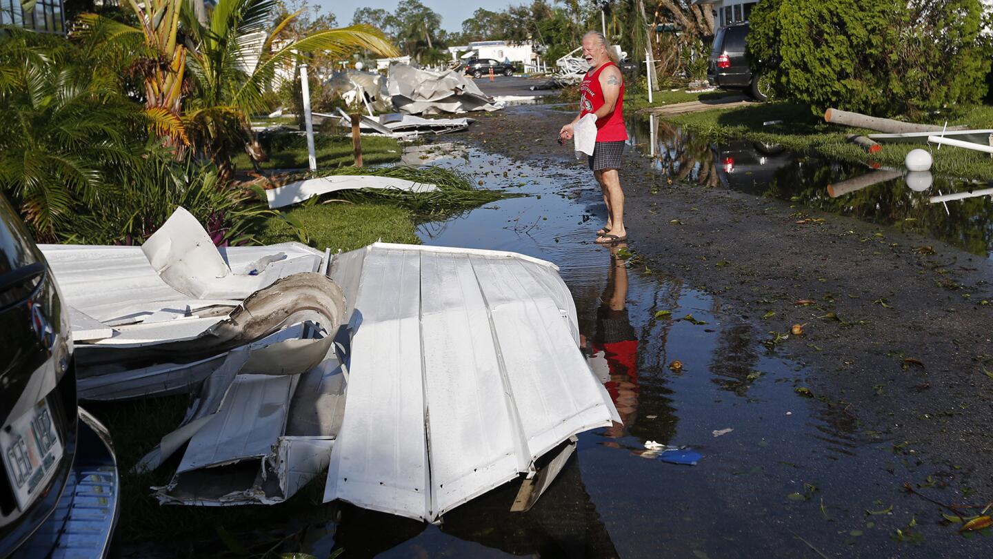 Todd Hart looks at the damage to his destroyed home in the Naples Estates mobile home park, in the aftermath of Hurricane Irma, in Naples, Fla., Tuesday, Sept. 12, 2017.