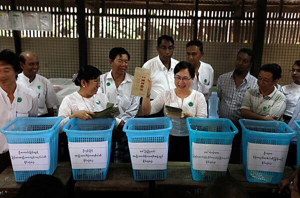 An election official displays a ballot in Myanmar