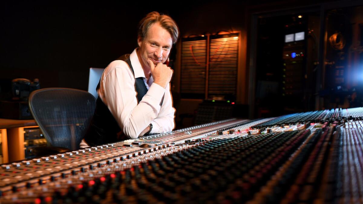 Producer Giles Martin (son of original Beatles producer George Martin) sits at the mixing console at Capitol Records in L.A.