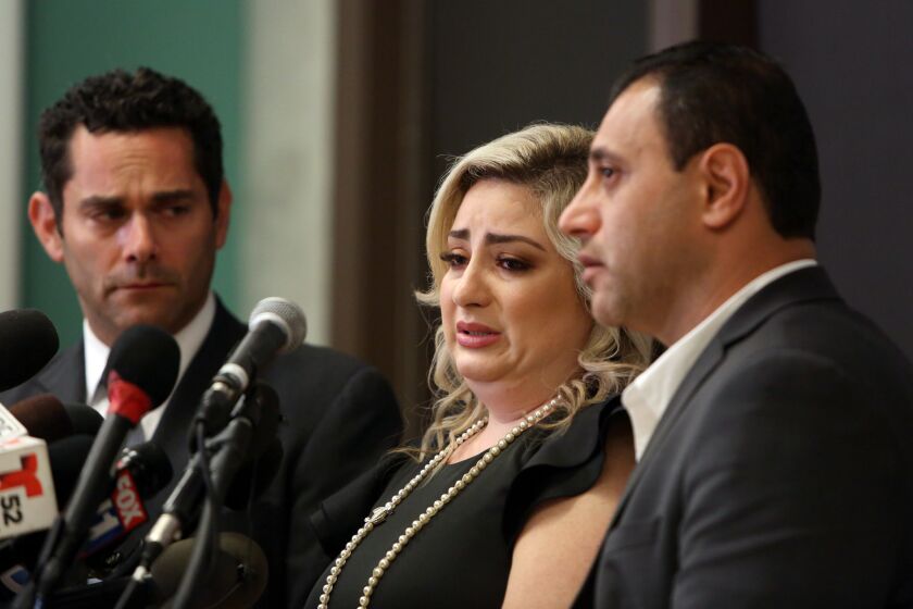LOS ANGELES, CA-JULY 10, 2019: Anni Manukyan, center, speaks with Peiffer Wolf & Kane Attorney Adam Wolf, left, and husband Ashot Manukyan, right, during a press conference about the alleged mix-up over a mishandled IVF treatment that left a New York woman pregnant with her biological baby at La Plaza de Cultura y Artes on July 10, 2019, in Los Angeles, California. (Photo By Dania Maxwell / Los Angeles Times)
